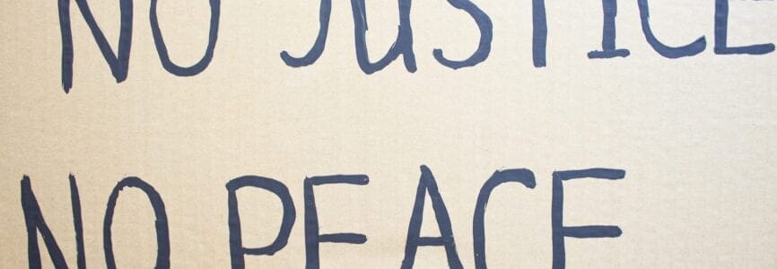 NO JUSTICE NO PEACE. Text message for protest on cardboard. Stop