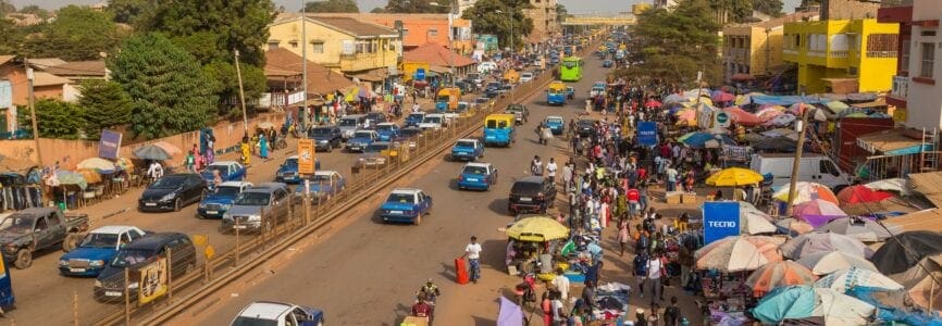 Bissau, Republic of Guinea-Bissau - January 6, 2020: Street scene in the city of Bissau with cars in a road, Guinea Bissau