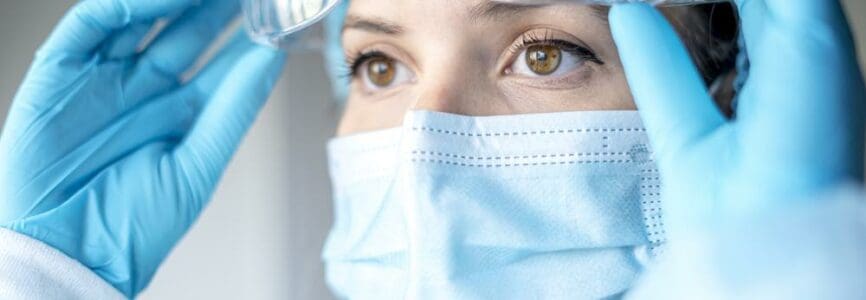 A portrait of a female medical doctor wearing a face mask and cap for patients surgery work