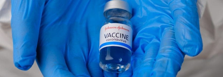 Johnson and johnson coronavirus vaccine in doctors or nurses hands in blue rubber gloves. Prevention of sars-cov-2 or Covid-19, January 2021, San Francisco, USA