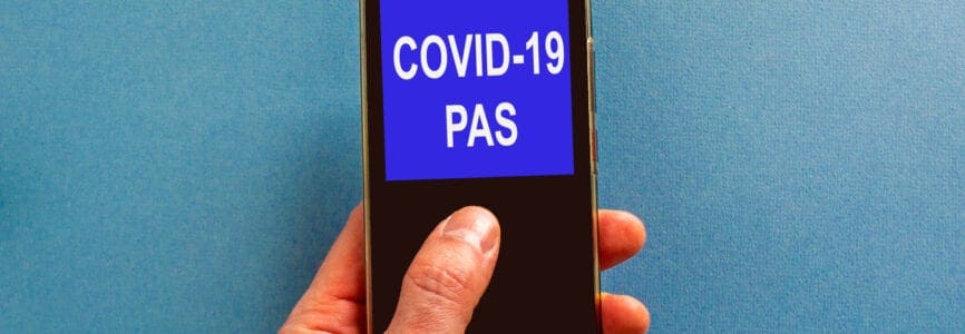 COVID-19 pas symbol. Businessman clicks on smartphone screen with words 'covid-19 pas' on the beautiful blue background. COVID-19 pas coronavirus pandemic concept.