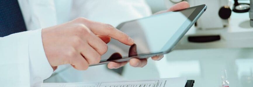 close-up. Scientist working on a tablet and going over research notes.