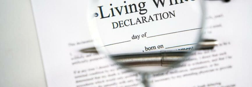 Living will declaration form seen through magnifying glass.