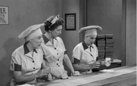 b&w photo of women working in a chocolate factory