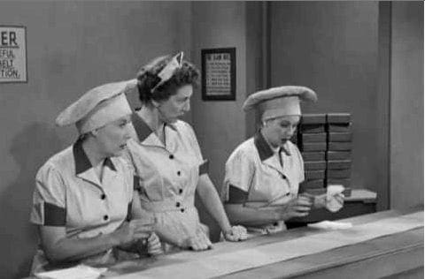 b&w photo of women working in a chocolate factory