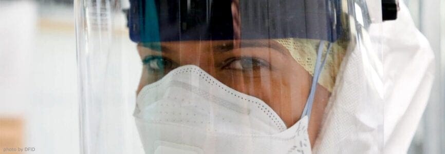 woman of color with a white mask and ear cover