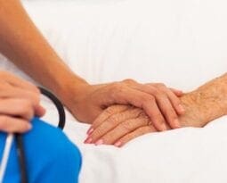doctor holding hands with patient