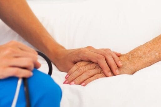 doctor holding hands with patient