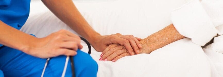 doctor holding hands with patient