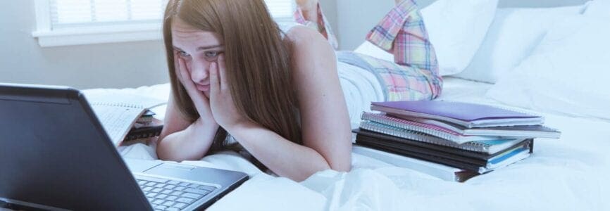 girl on bed with computer