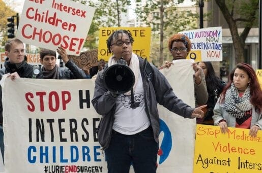 protesters holding various signs