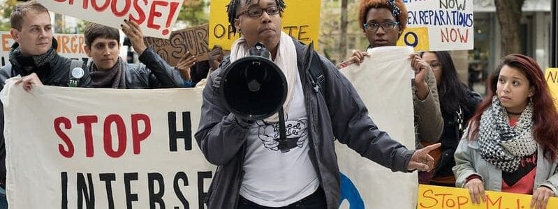 protesters holding various signs