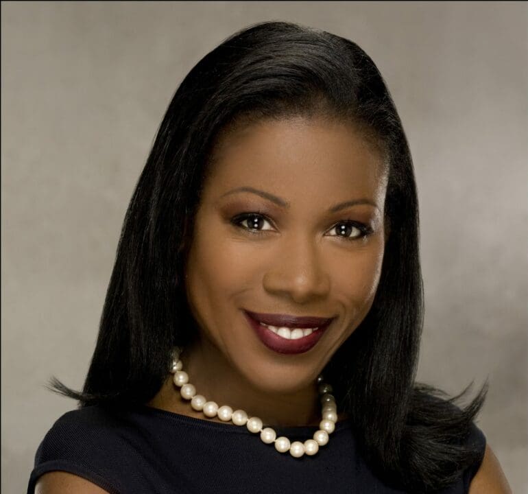 young black woman with pearls and a black dress