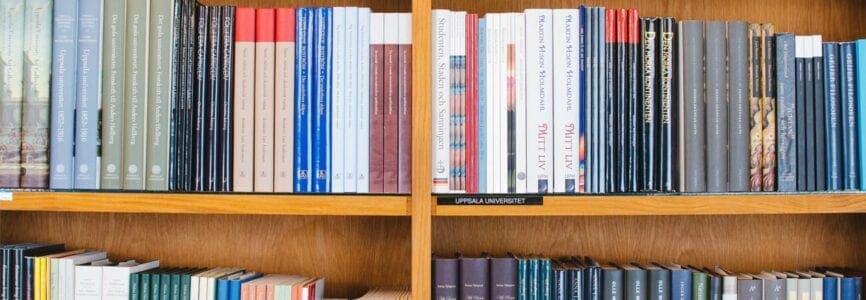 medical books stacked on wooden shelves