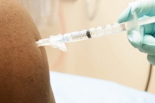 Syringe going into patients arm