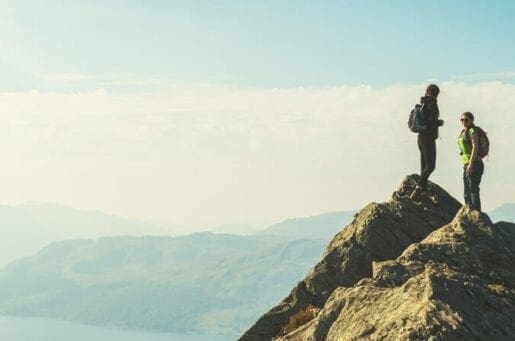 Couple summiting a mountain