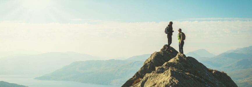 Couple summiting a mountain