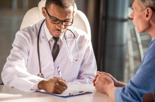 young black doctor helps older patient