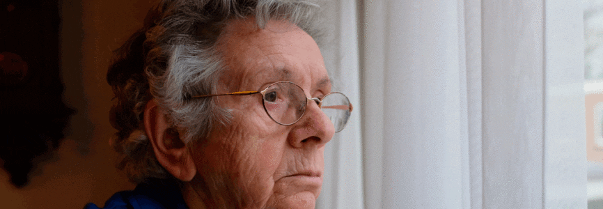 aging white man looking out a window