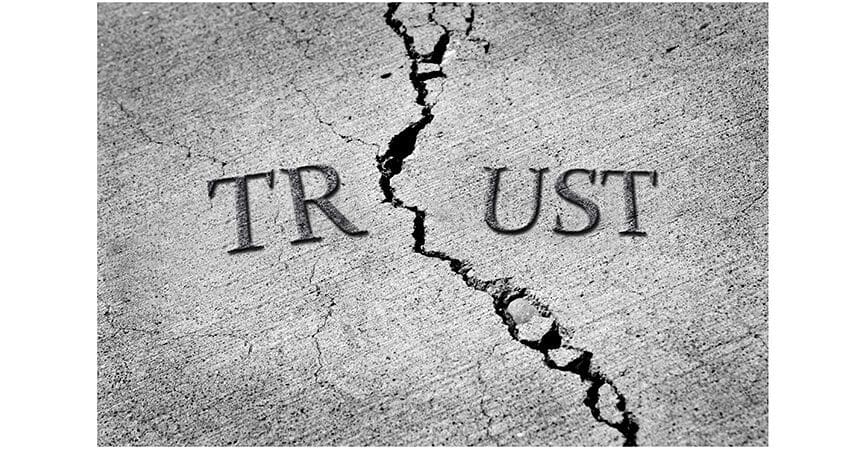 Cracked cement symbolizing broken trust between people or parties