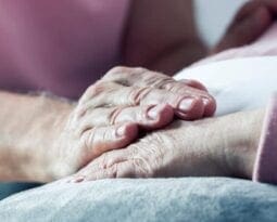 older women holding each others hands