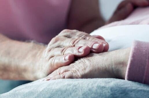 older women holding each others hands