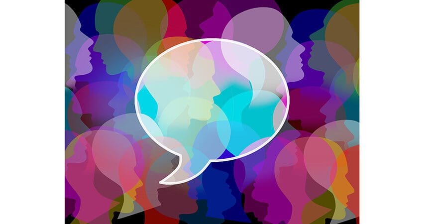People crowd symbol as a large public group shaped as a speach or chat bubble as an icon for society and population communication and social media discussion.
