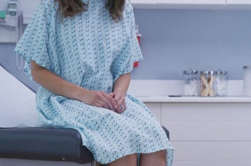 female patient sitting in exam room