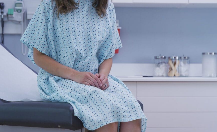 female patient sitting in exam room