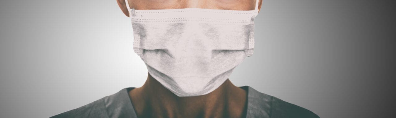 pandemic worker wearing a white surgical masks