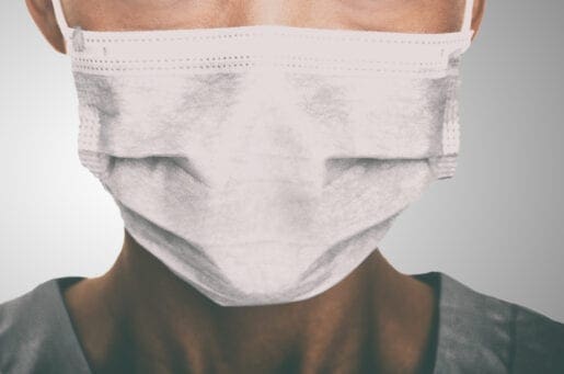 pandemic worker wearing a white surgical masks