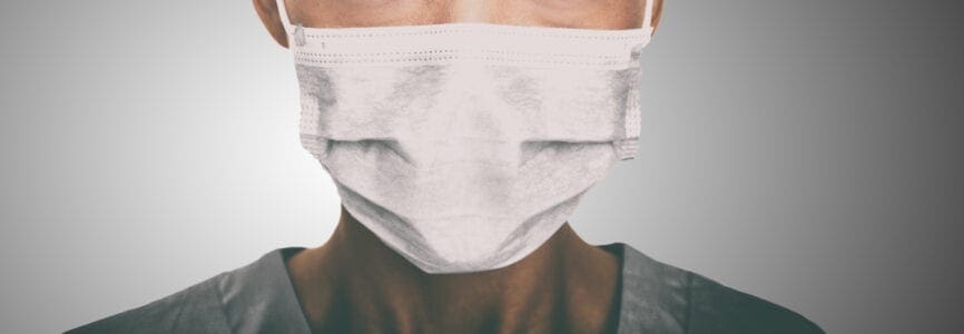 pandemic worker wearing a white surgical masks