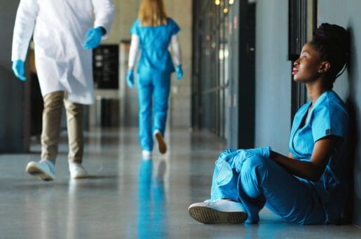 Tired,Sad,African,American,Woman,Doctor,In,Uniform,And,Gloves