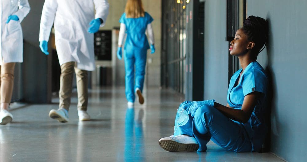 Tired,Sad,African,American,Woman,Doctor,In,Uniform,And,Gloves