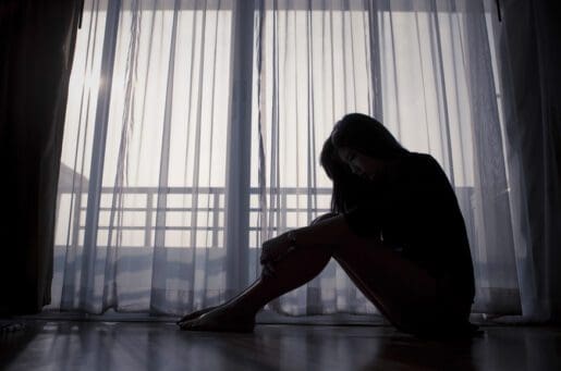 silhouette of woman in front of window