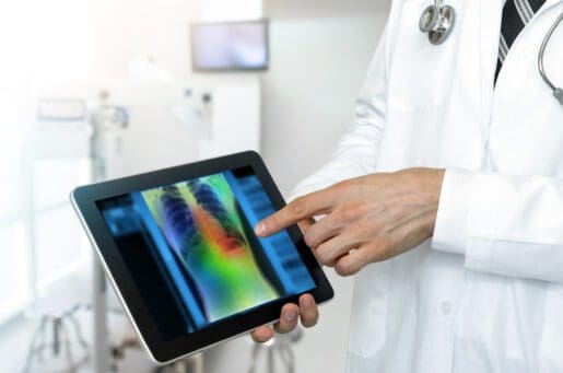 doctor pointing to tablet with medical image