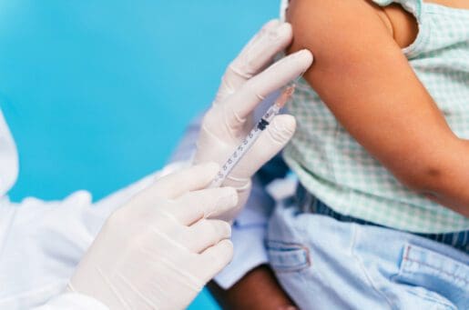 vaccine being injected into toddler's arm