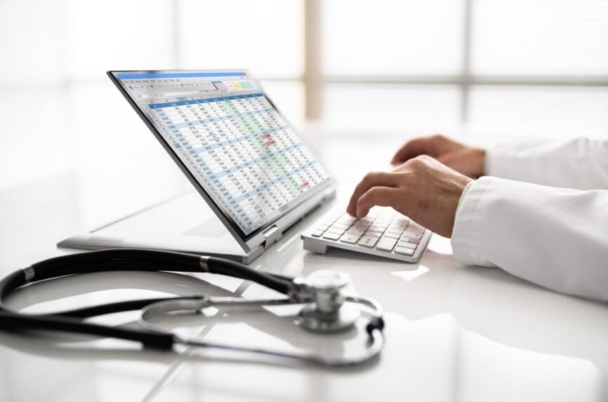 clinician typing medical code on keyboard